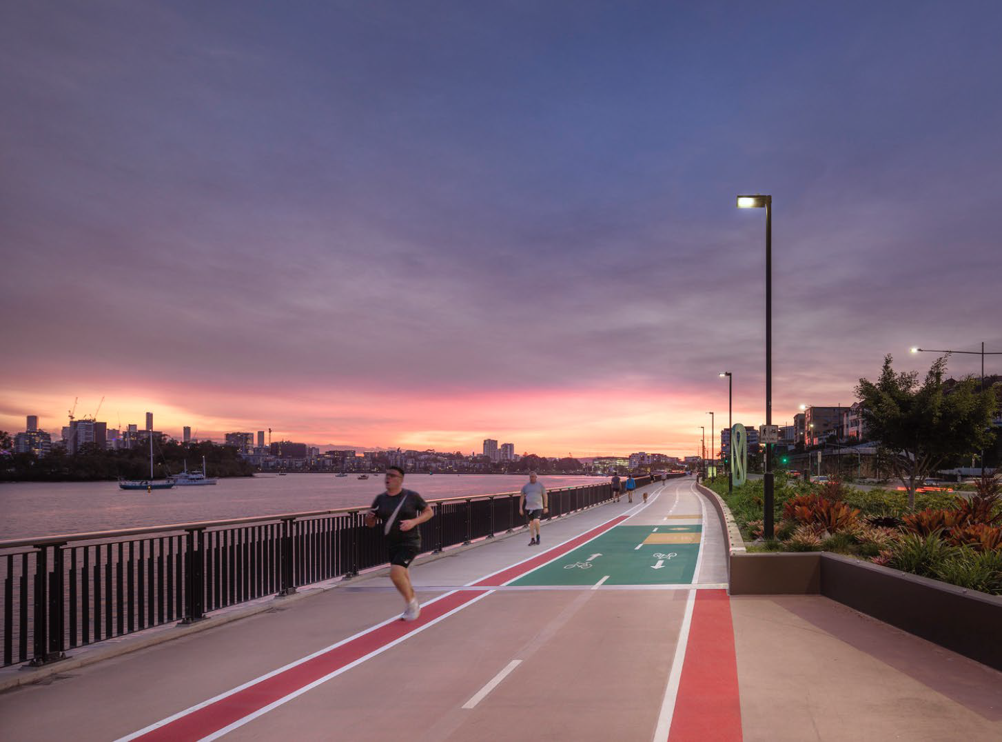 Runners running down a street at night