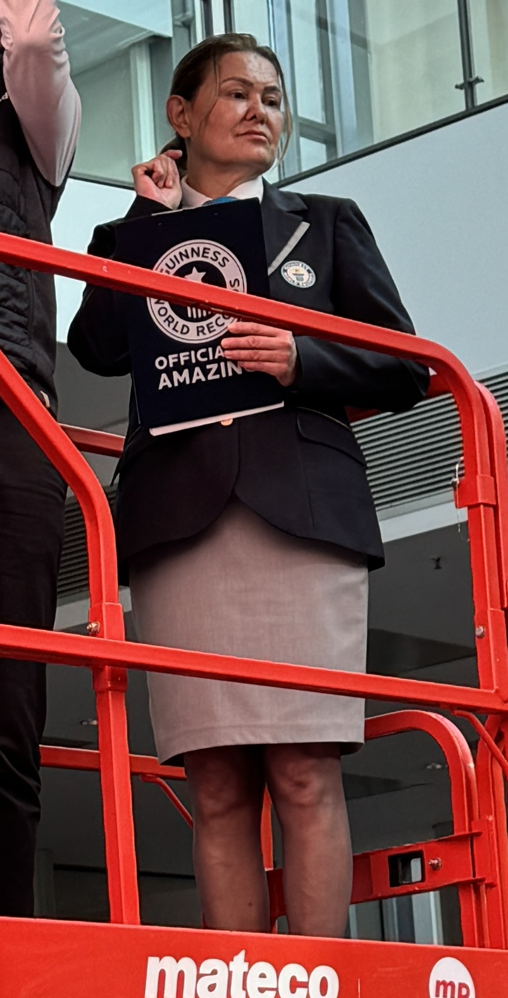 Lady holding a folder that says Guinness World Records