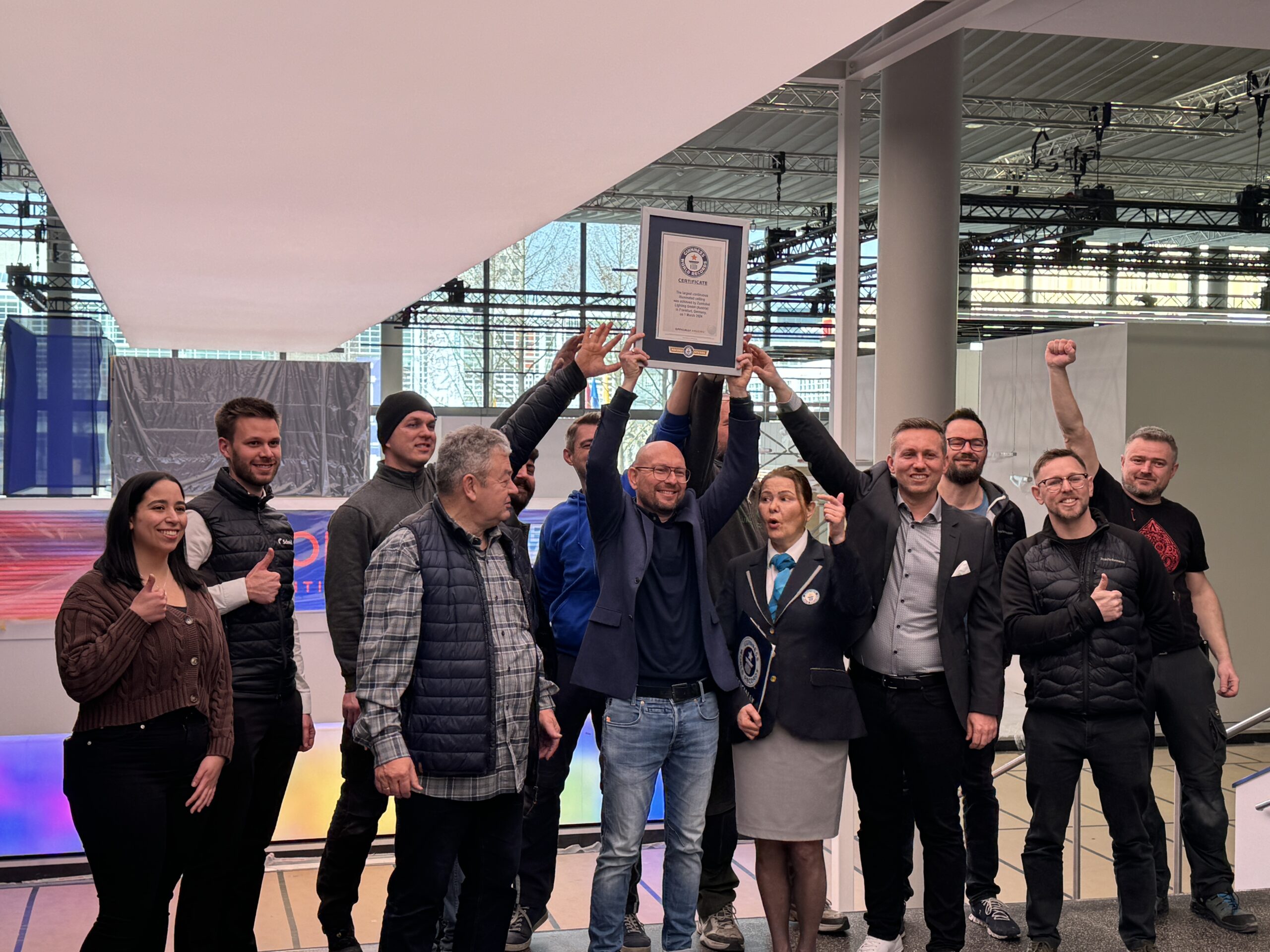 Zumtobel Team Holds Guinness World Record Plaque at Light & Building 2024