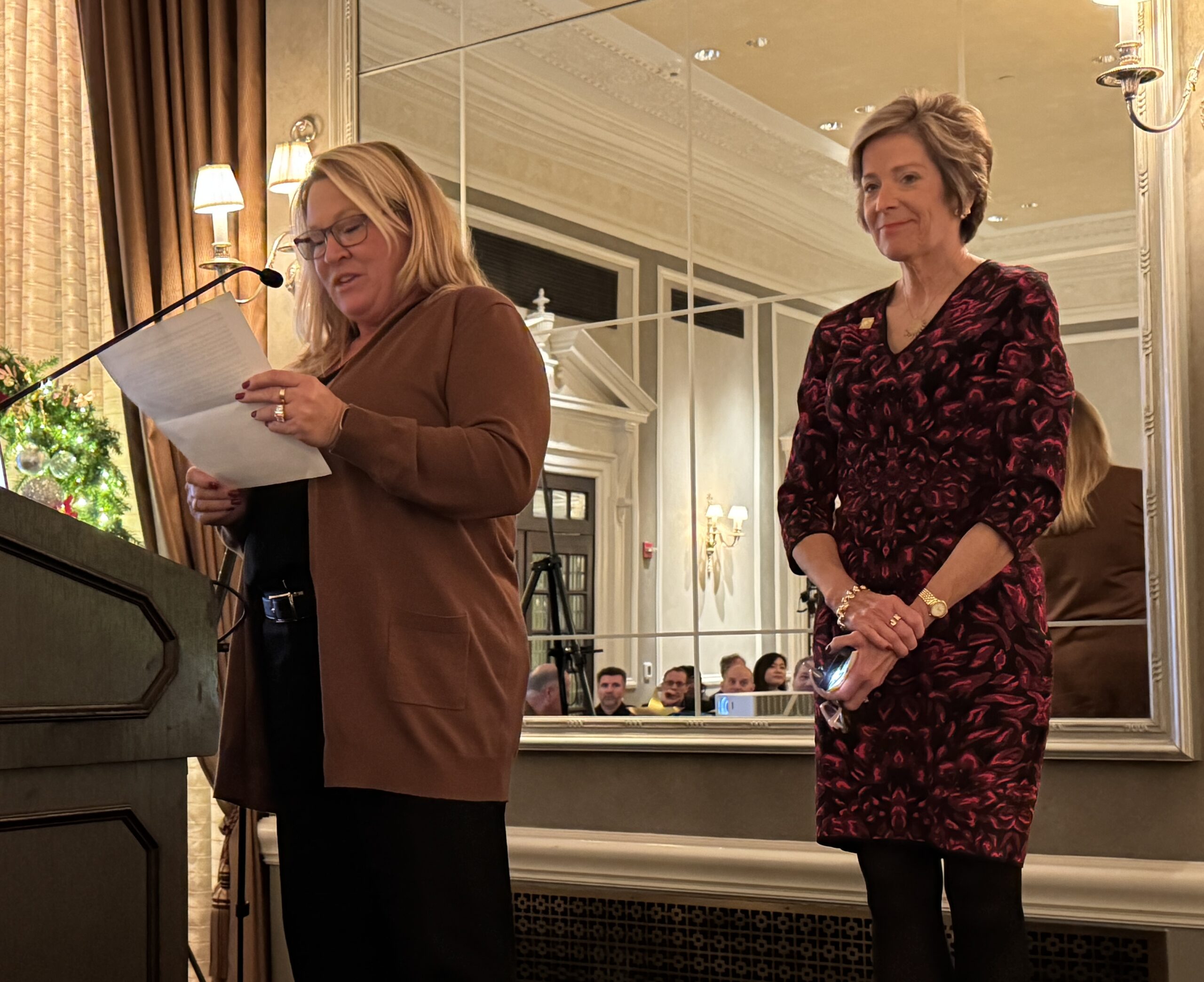 Michigan Lighting Hall of Fame Inductee, Jana Brownell, looks on as she is introduced by Michelle Prew, incoming IES Detroit President