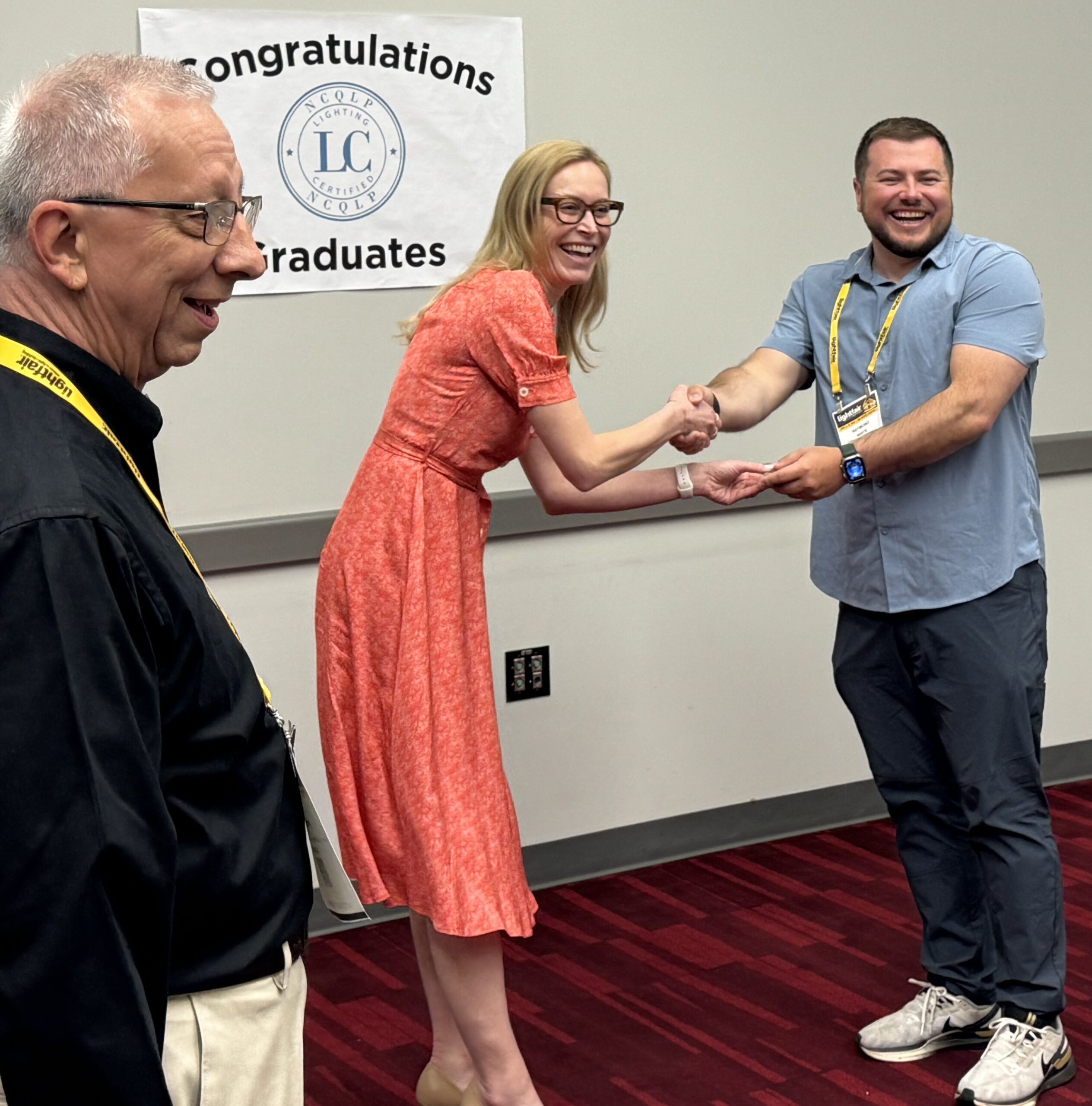 A very happy Colleen Harper Hands out the first pin at the Sonepar LC Breakfast at LightFair 2025